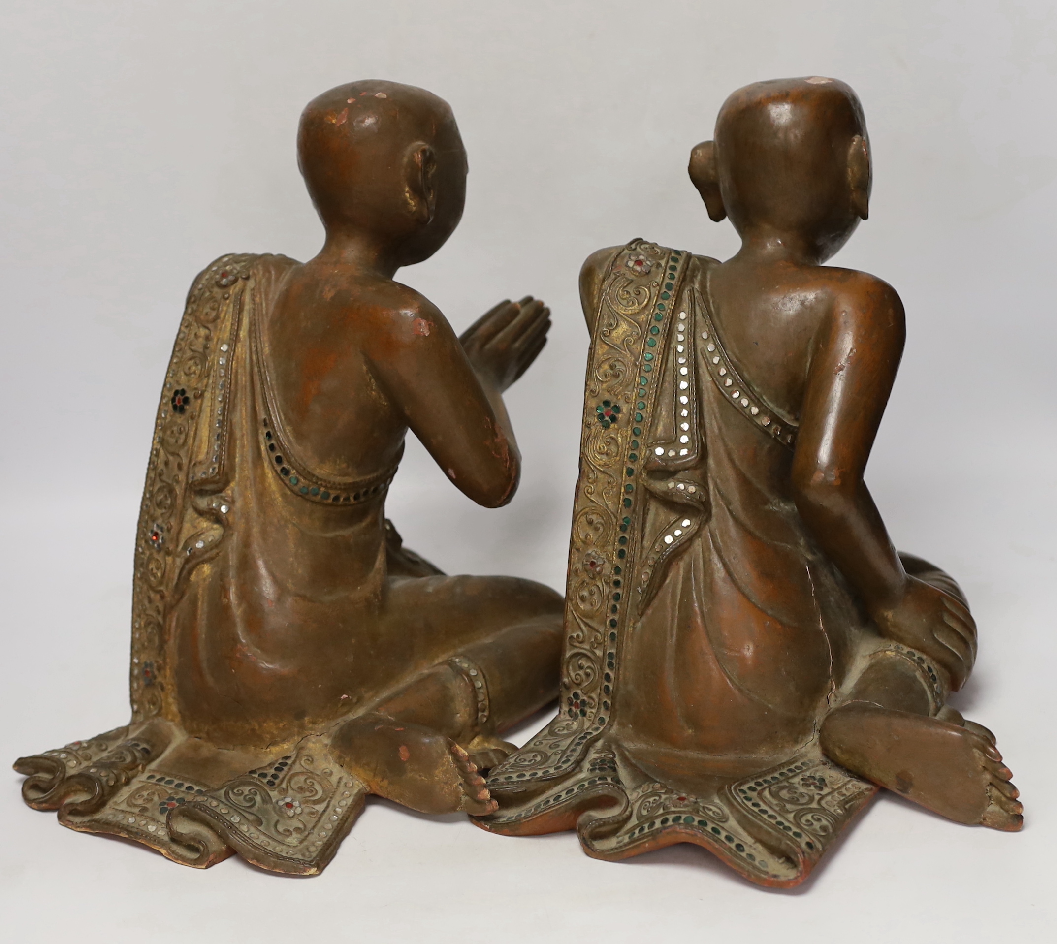 Two papier-mâché and lacquer Thai praying monks, 29.5cm high